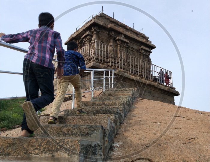 Children running to reach the top of the temple