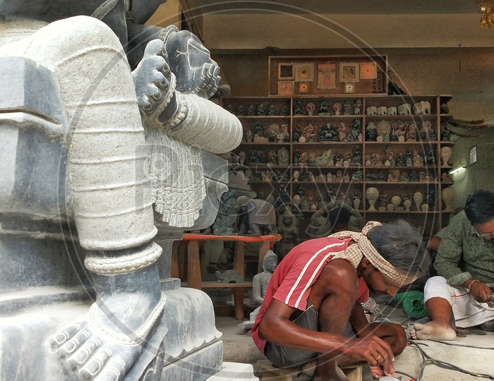 Worker doing the final modifications for the Lord Ganesh satue which is made of Special Stone at mahabalipuram
