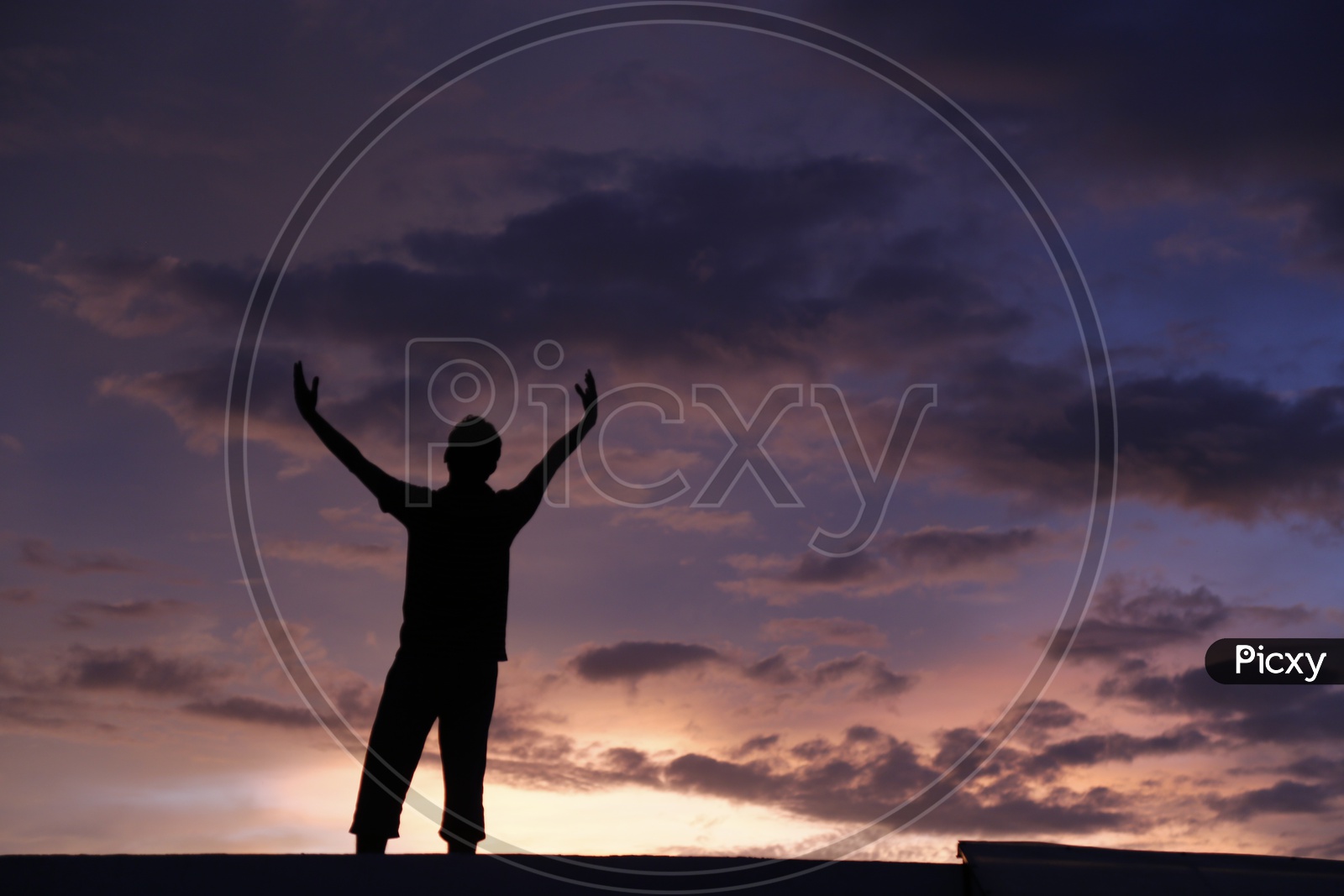 Silhouette Of a  Young man Over a Sunset Sky