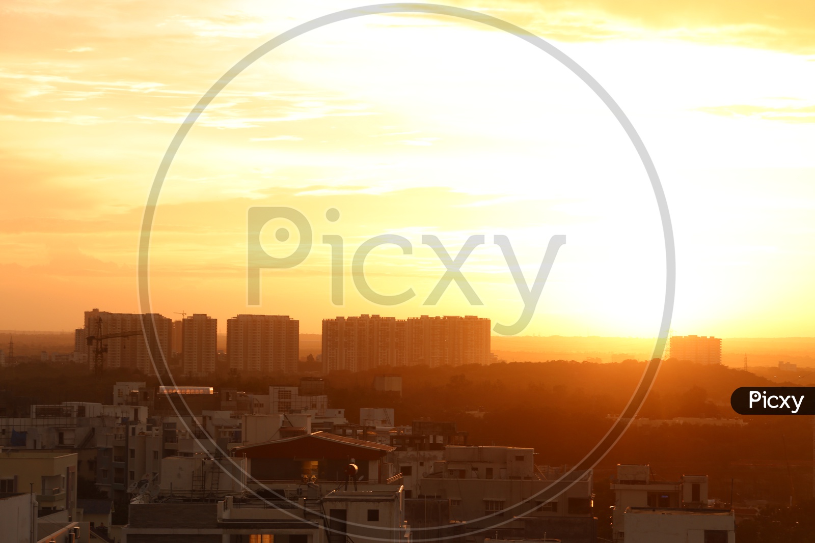 City Scape With High Rise Building And Apartments Over Sunset Sky