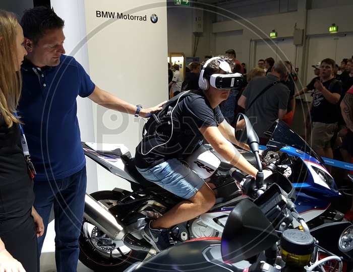 Man using Virtual Reality Headset driving simulator on BMW Bike