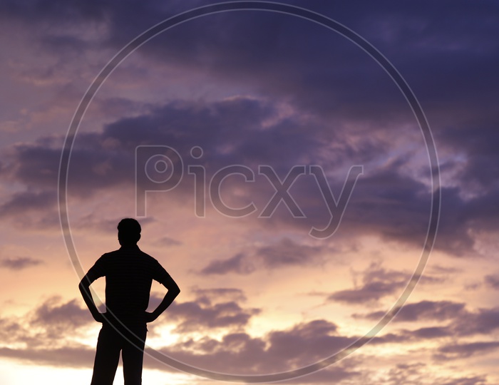Silhouette Of a  Young man Over a Sunset Sky