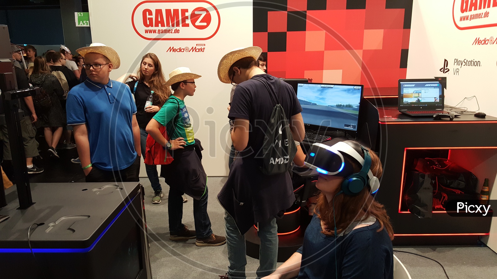 Young Woman using Virtual Reality Headset and Kids playing games at GameZ Stall
