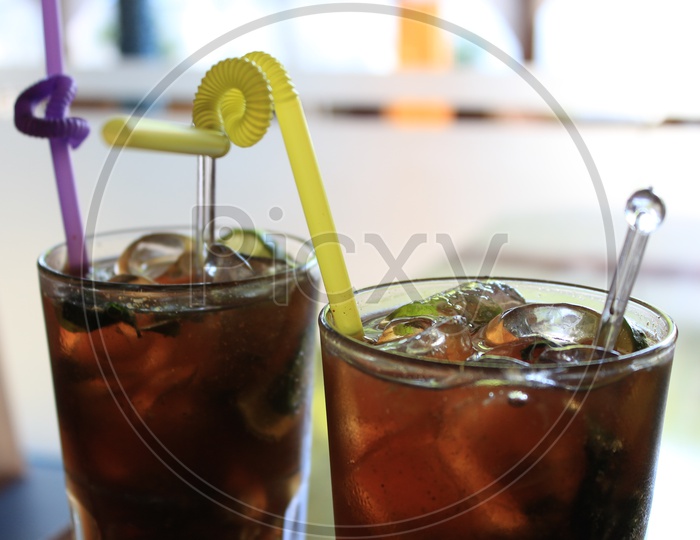 Mocktail  Cocktail Ice Tea  In a Glass With Straw on a restaurant Table