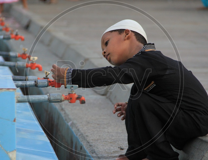 Children At The Taps near  Water Pool in Mecca Masjid
