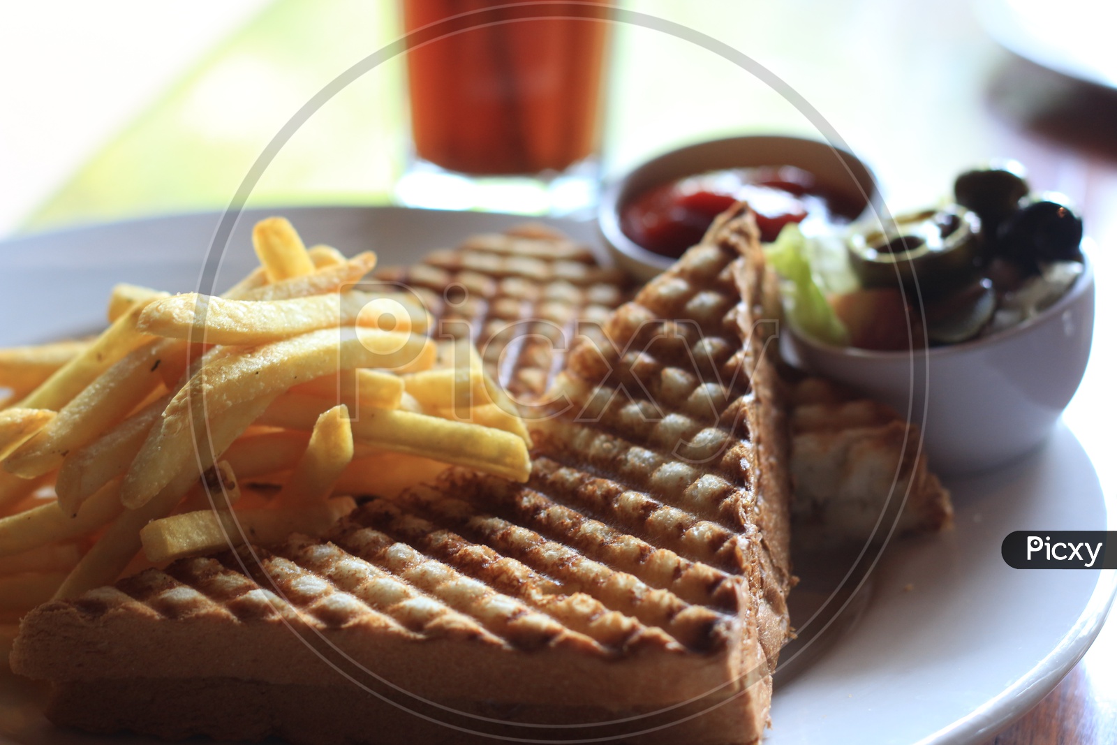 Grilled Sandwich With French fries  in a Restaurant Table
