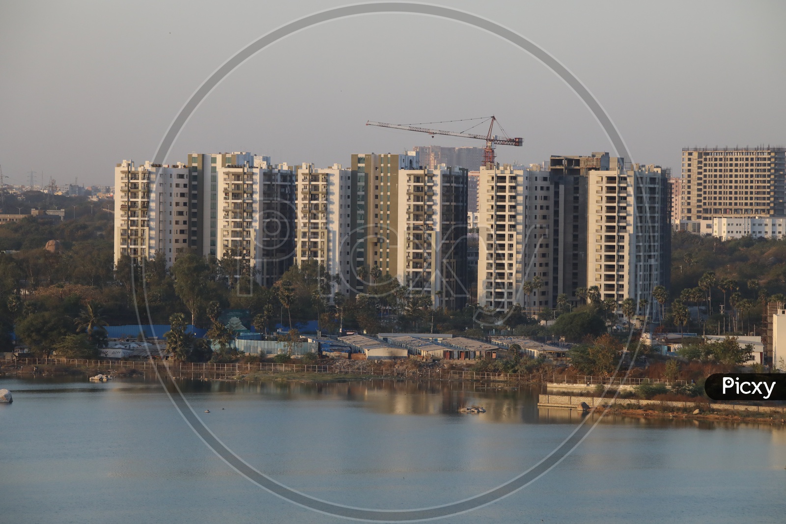 A View Of High Rise Under construction  Building from a Hill top on a Lake Side