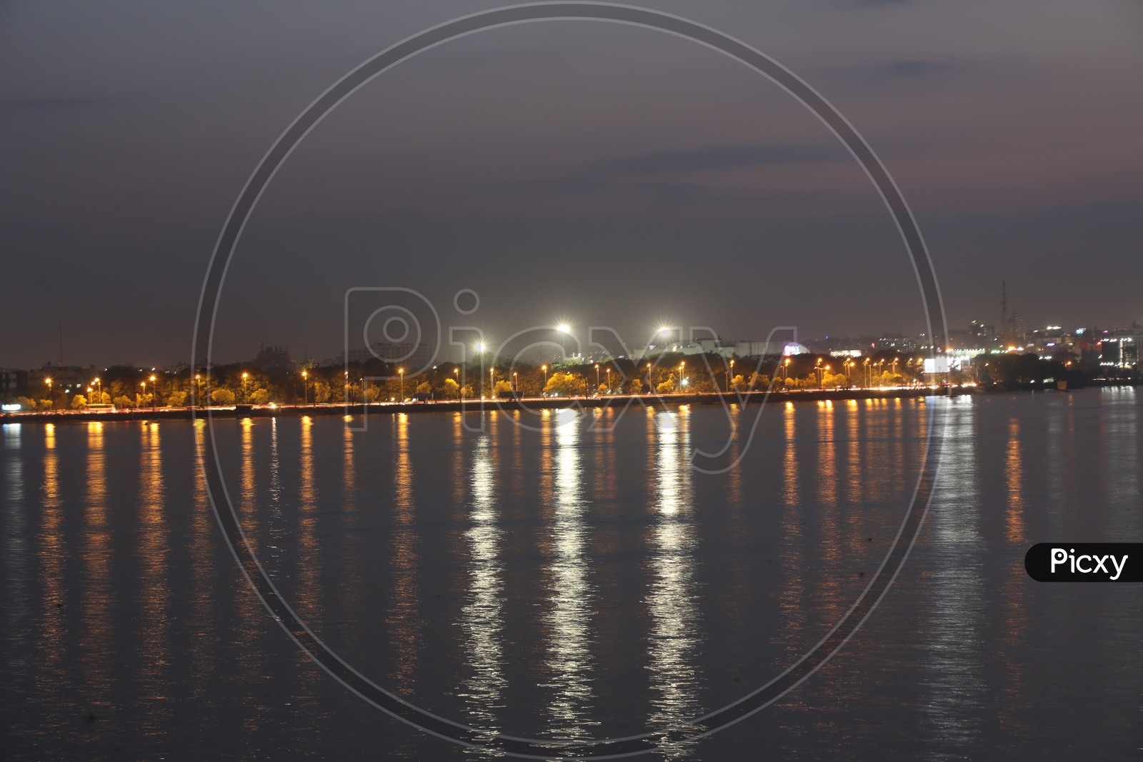 Hussain Sagar Buddha Statue With The reflection of Street Lights on Water Surface