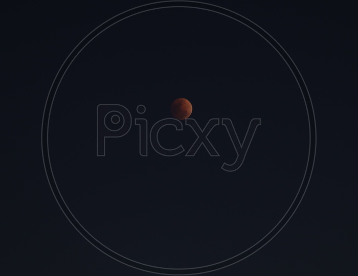 Eclipse Moon  Blood red Moon Isolated On Dark Sky