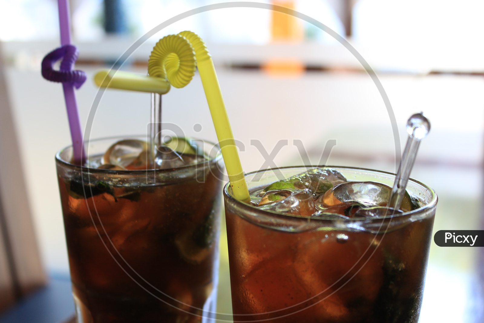 Mocktail  Cocktail Ice Tea  In a Glass With Straw on a restaurant Table