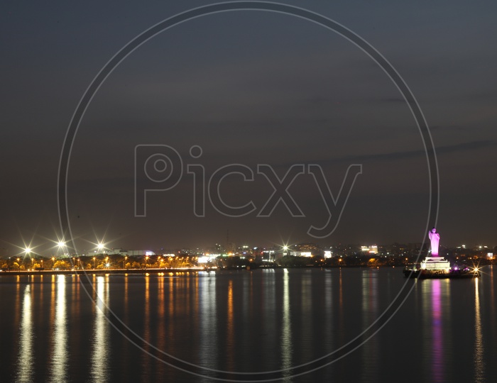 Hussain Sagar Buddha Statue With The reflection of Street Lights on Water Surface