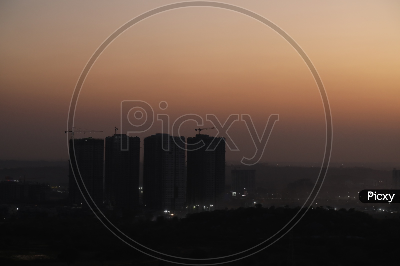 City Scape With High Rise Building in Night Time With City Lights  From a Hill top