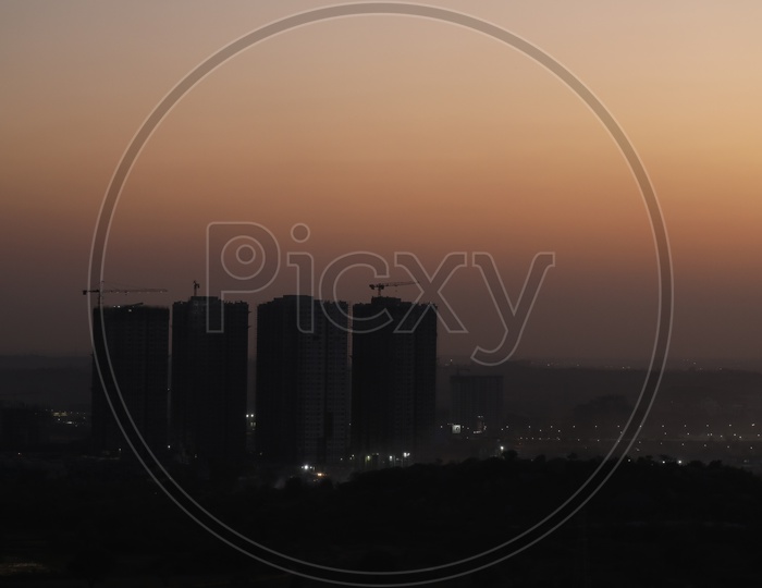 City Scape With High Rise Building in Night Time With City Lights  From a Hill top