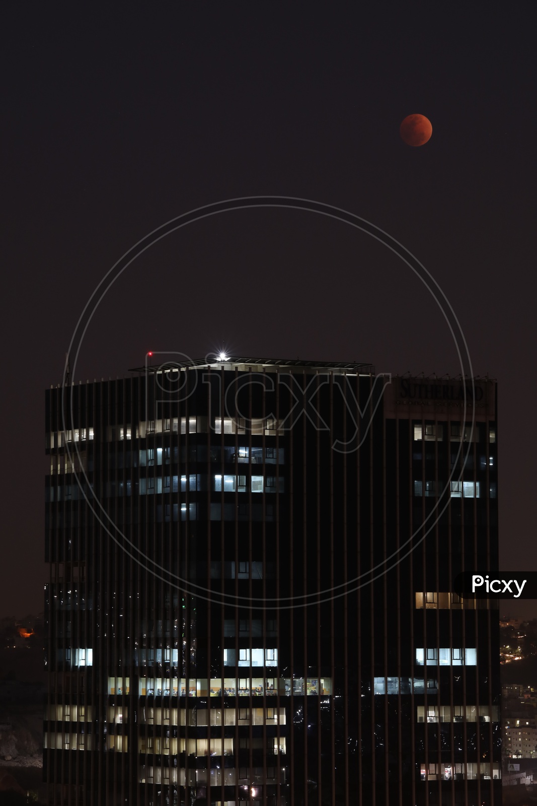 Sutherland Building Facade With A View of Eclipse Moon  in Sky
