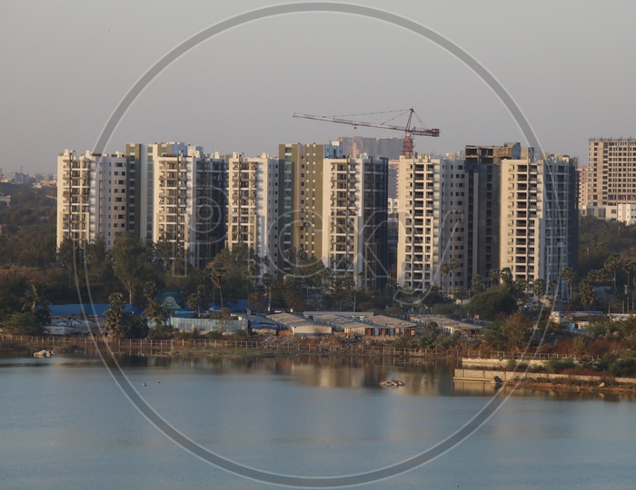 A View Of High Rise Under construction  Building from a Hill top on a Lake Side