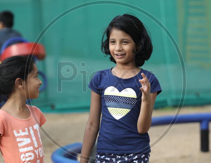 Girl Child With Happy Face Playing In a Park