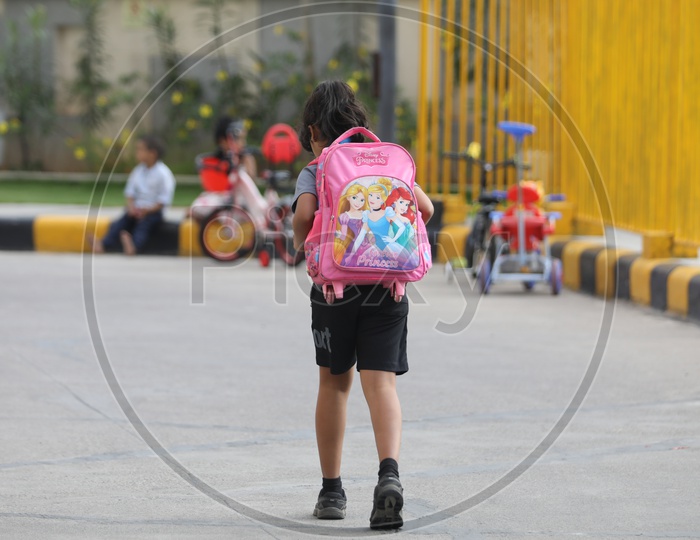 School Girl Carrying a School bag On Back