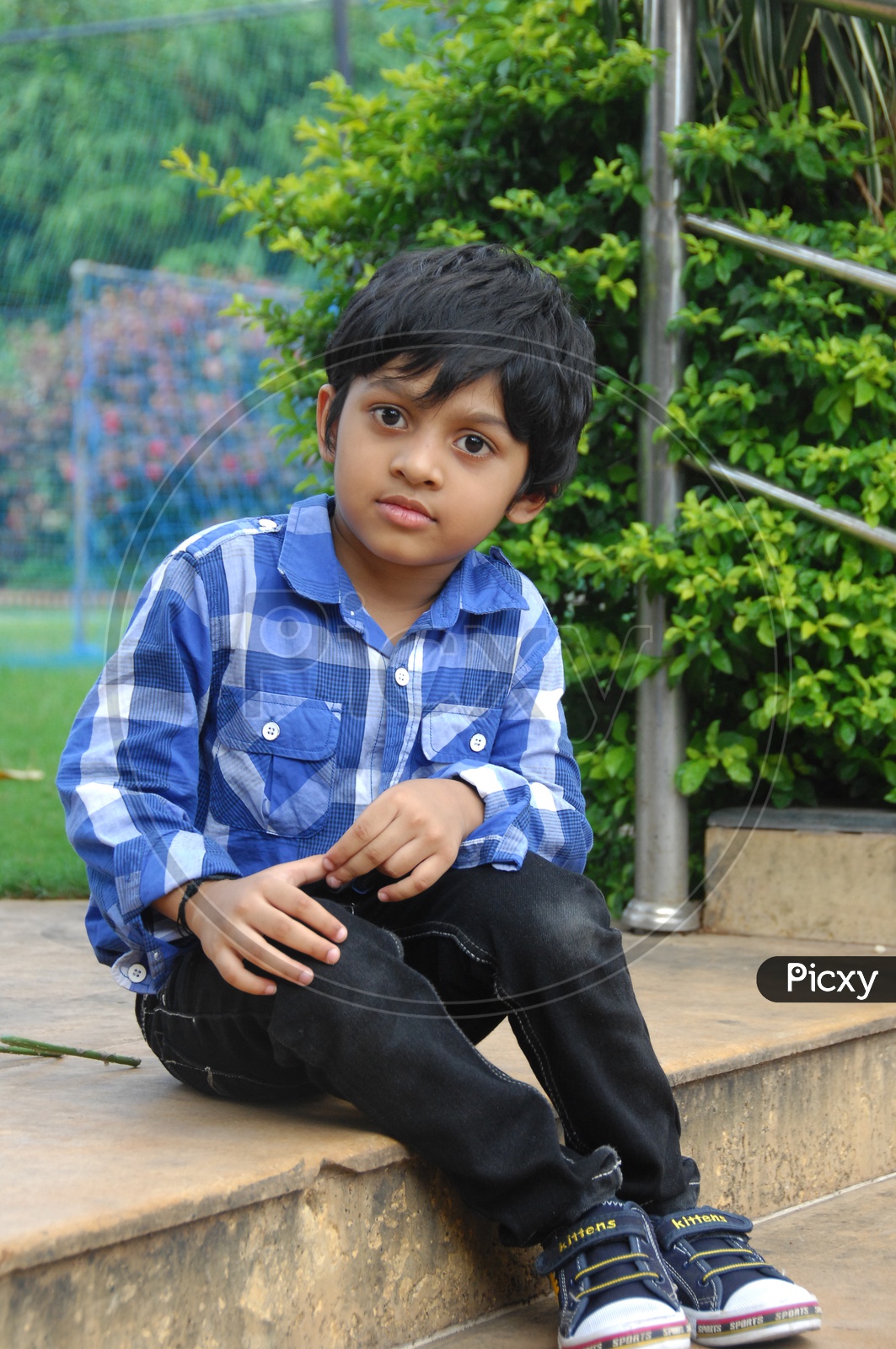 Young boy poses and smiles for camera in photoshoot Stock Photo by  ©elfachero3@gmail.com 294043986