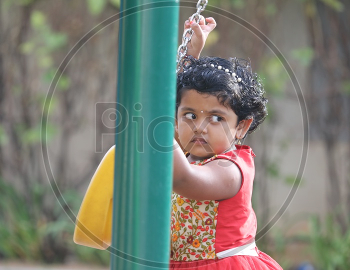 Indian Girl Child Playing In a Park