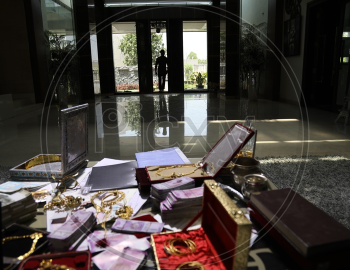 Jewellery And Cash Bundles  on a Table In a House