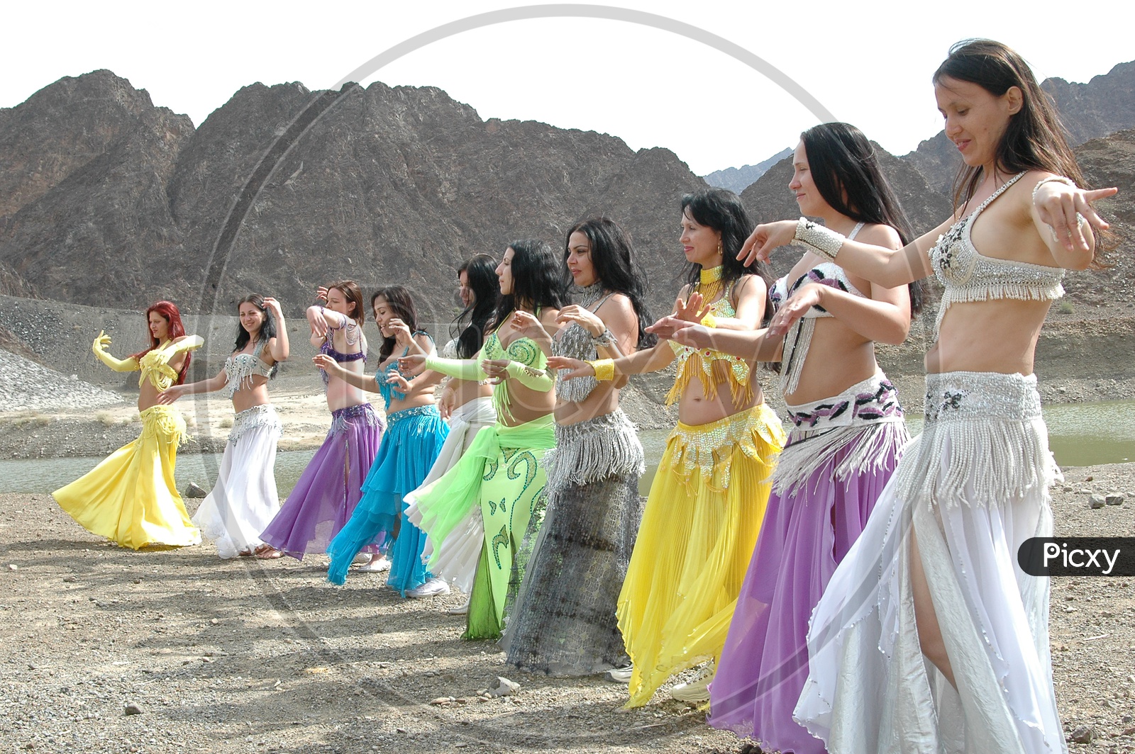 Dancers belly Dancing At Sedimentary Rock  Dunes  For a movie Shooting