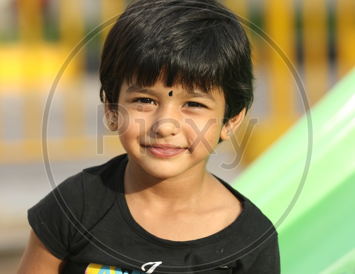 Indian Girl Child With Happy Face In a Park