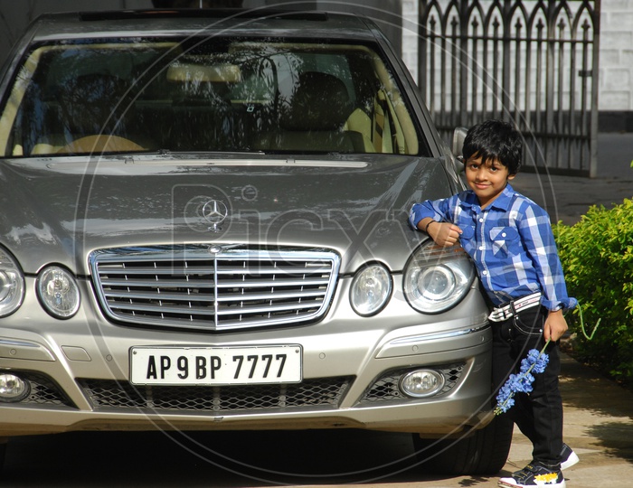Young boy Posing at a Benz Car