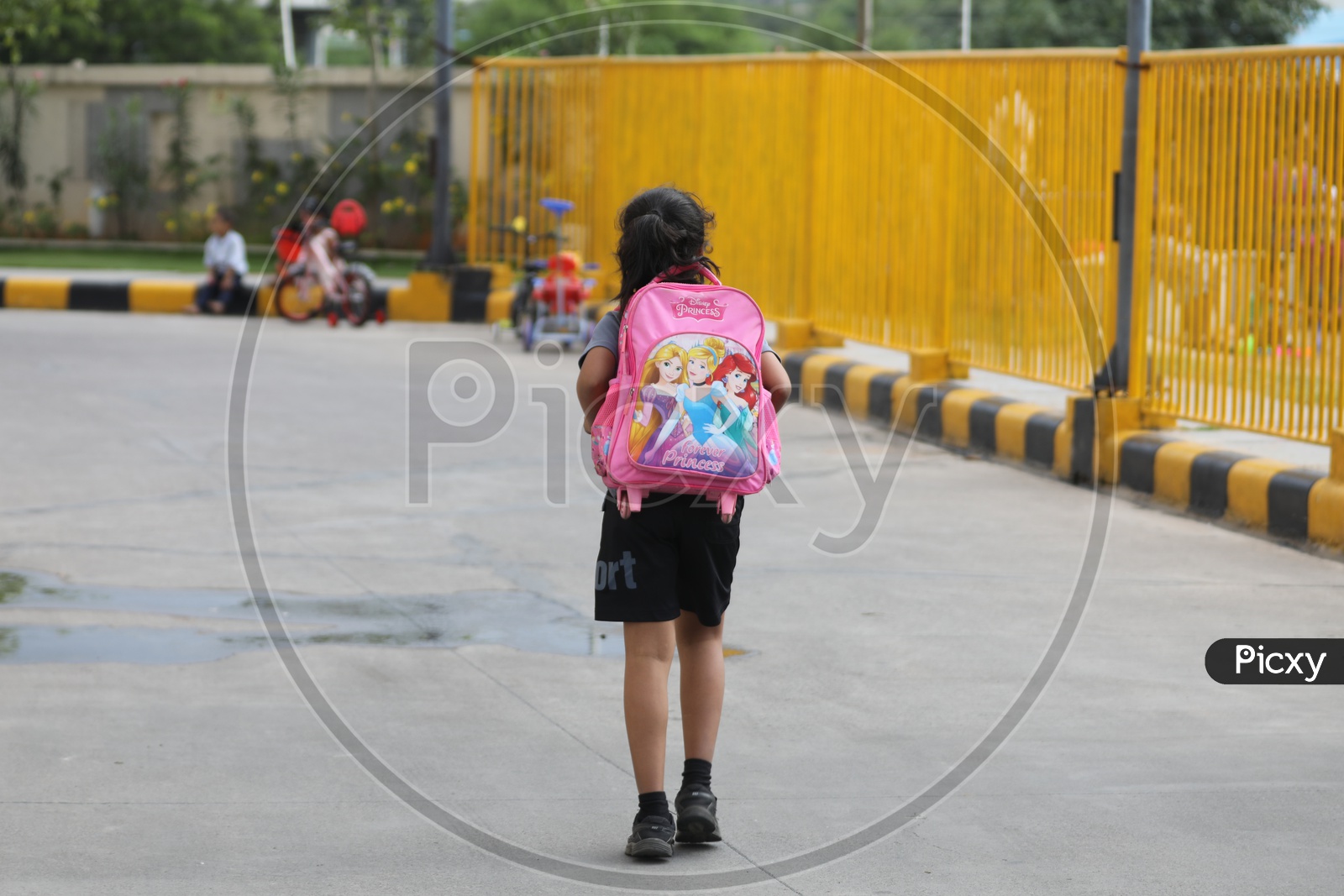 School Girl Carrying a School bag On Back
