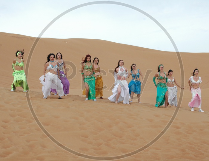 Dancers on The  Sand Dunes of Deserts For a Movie Song Shoot