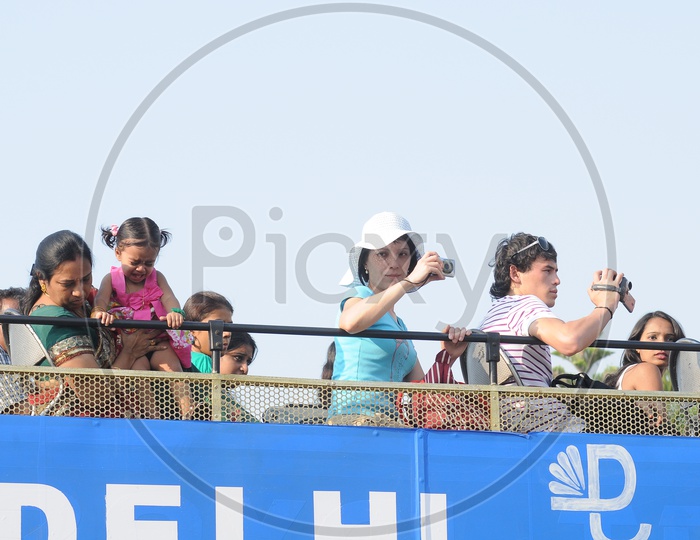 A Mother Holding Daughter  on an Open top Bus