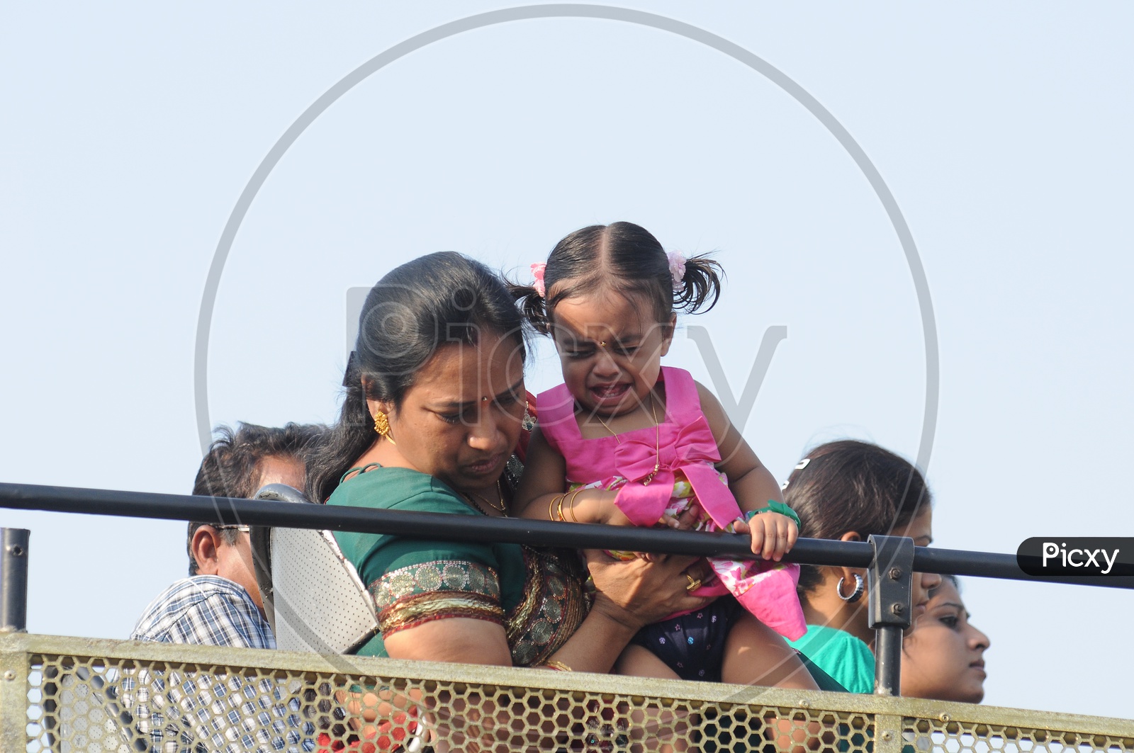 A Mother  Holding Daughter on an Open top Bus