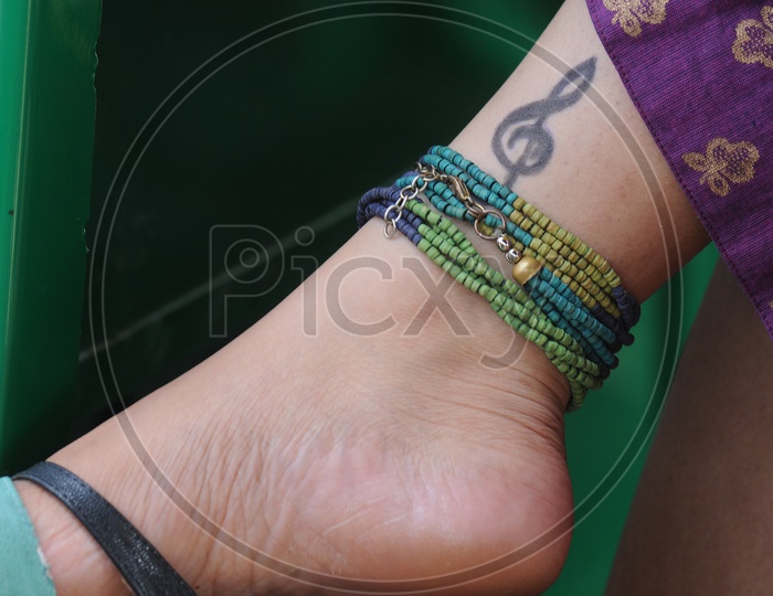 Young  Woman  Leg With Music Note Tatoo