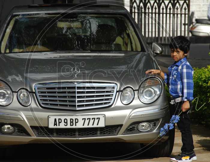 Young boy Posing at a Benz Car