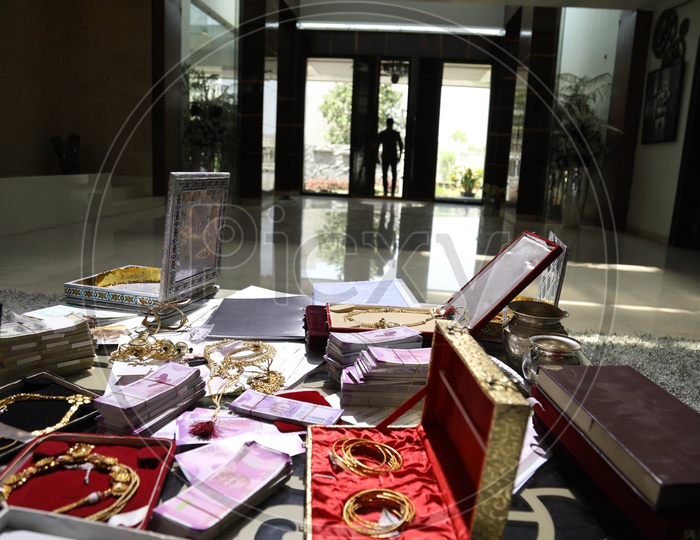 Jewellery And Cash on a Table In a House