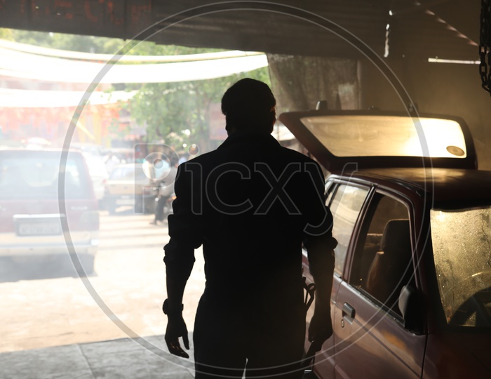 Silhouette Of a Man in an Auto Garage