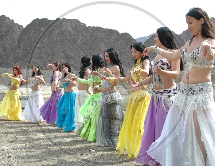 Dancers Belly Dancing At Sedimentary Rock  Dunes  For a movie Shooting