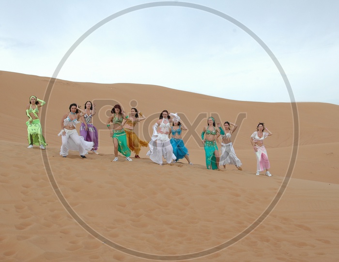 Dancers on The  Sand Dunes of Deserts For a Movie Song Shoot