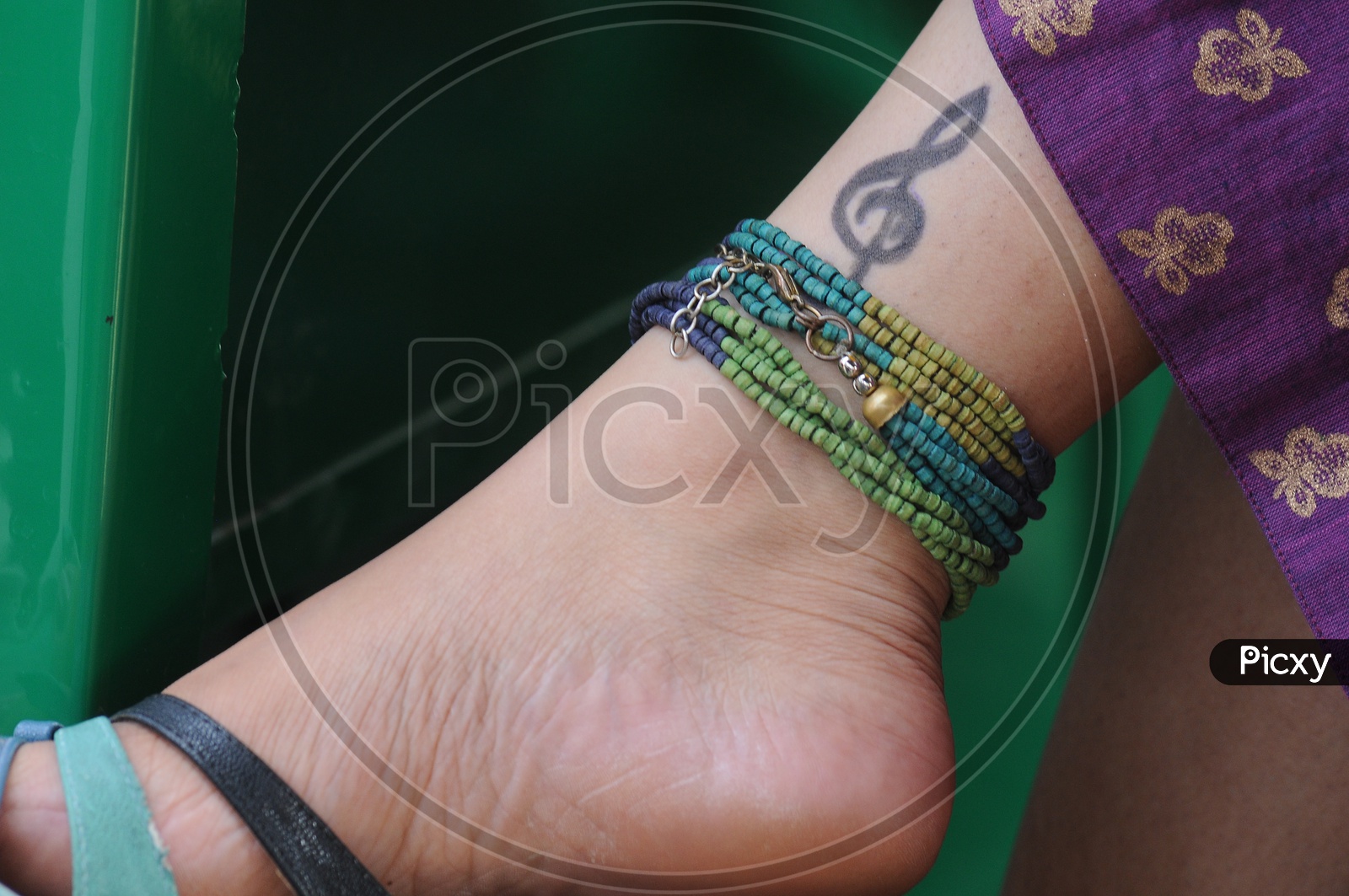 Young  Woman  Leg With Music Note Tatoo