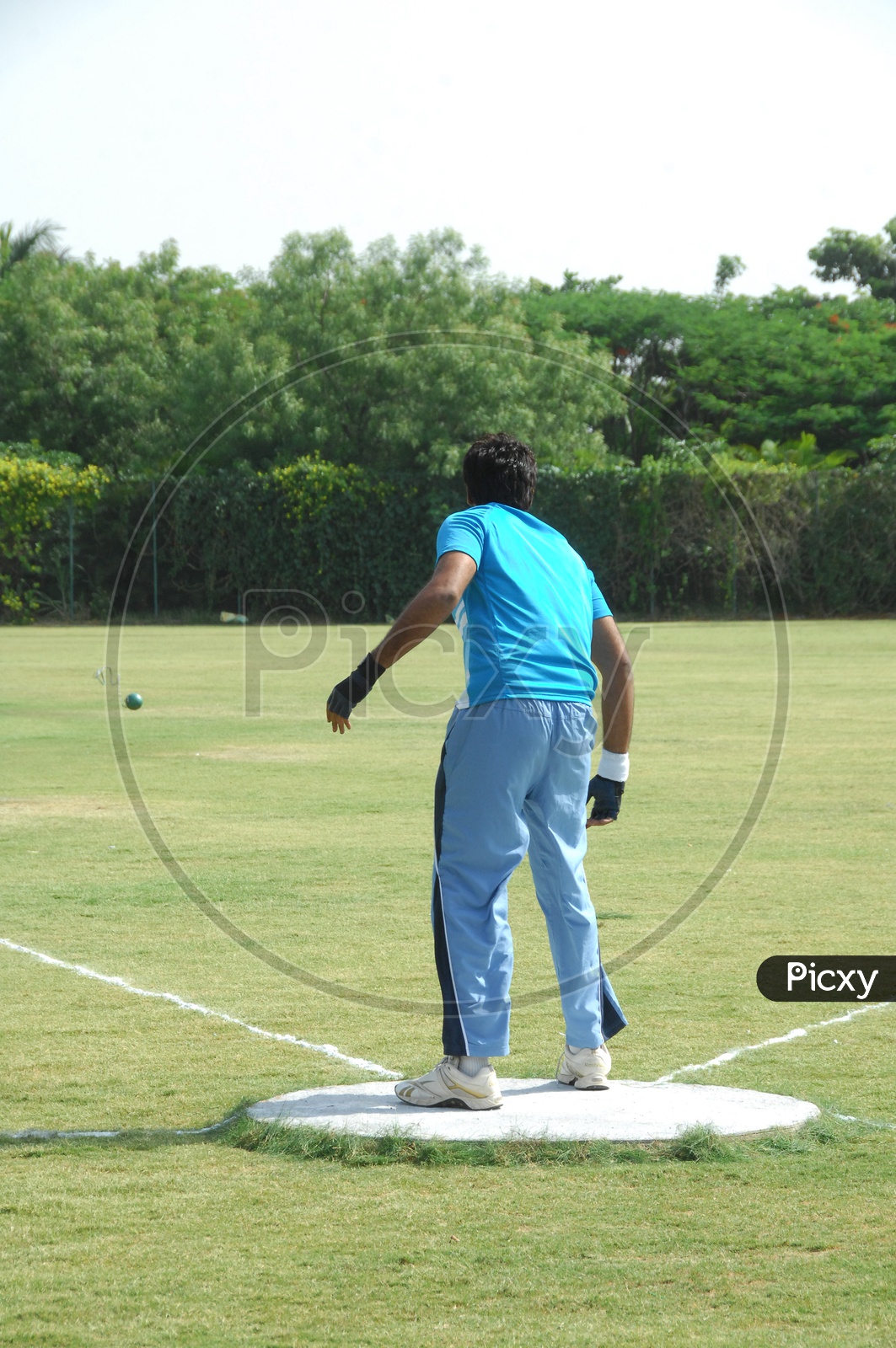 Shot Put Practice By a Sports Man In a Ground