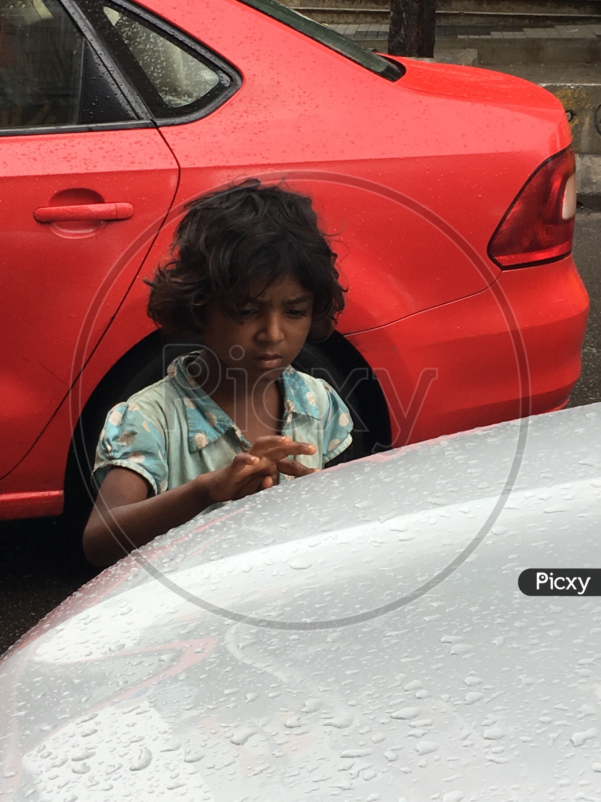 Girl Playing With Rain Droplets on a Car bannot