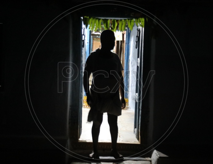 Silhouette Of an Indian Rural Village Man Standing at a House Door Step