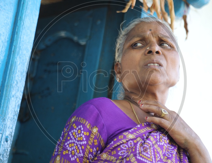 Indian old Woman of a Rural Village Standing at her House Door Step Or Entrance