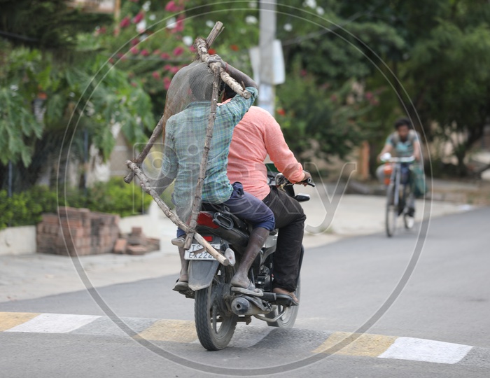 Daily Workers Of Construction Site Carrying Sieve Mesh in a Bike