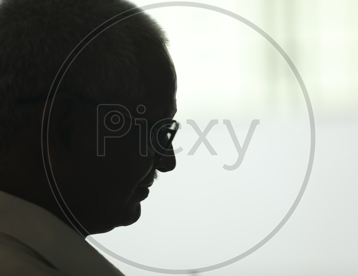 Silhouette Of a Thinking Indian Old Man Wearing Spectacles