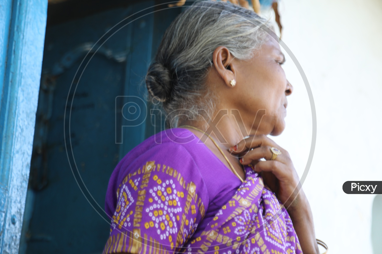 Indian old Woman of a Rural Village Standing at her House Door Step Or Entrance