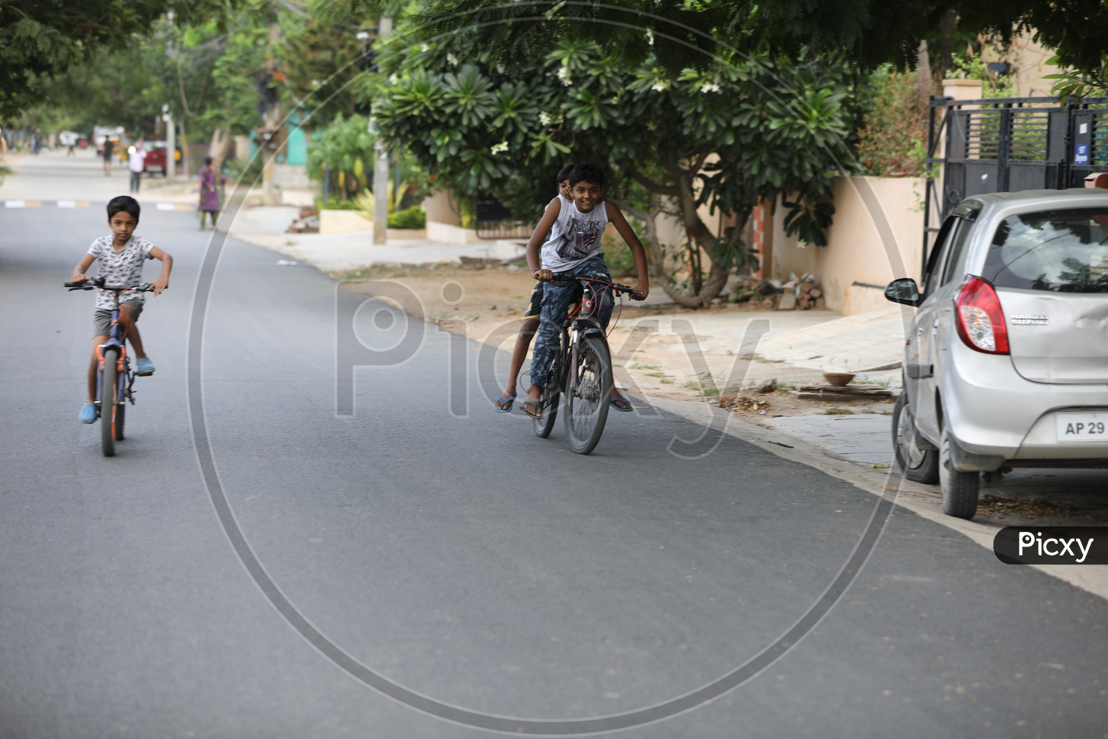 Indian urban Village Kids Or Children Riding Bicycles Or Cycles on The Roads