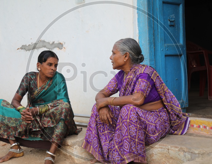 Indian Rural Village Woman  Sitting And Chit Chatting With Each Other At a house Door Step Or Entrance