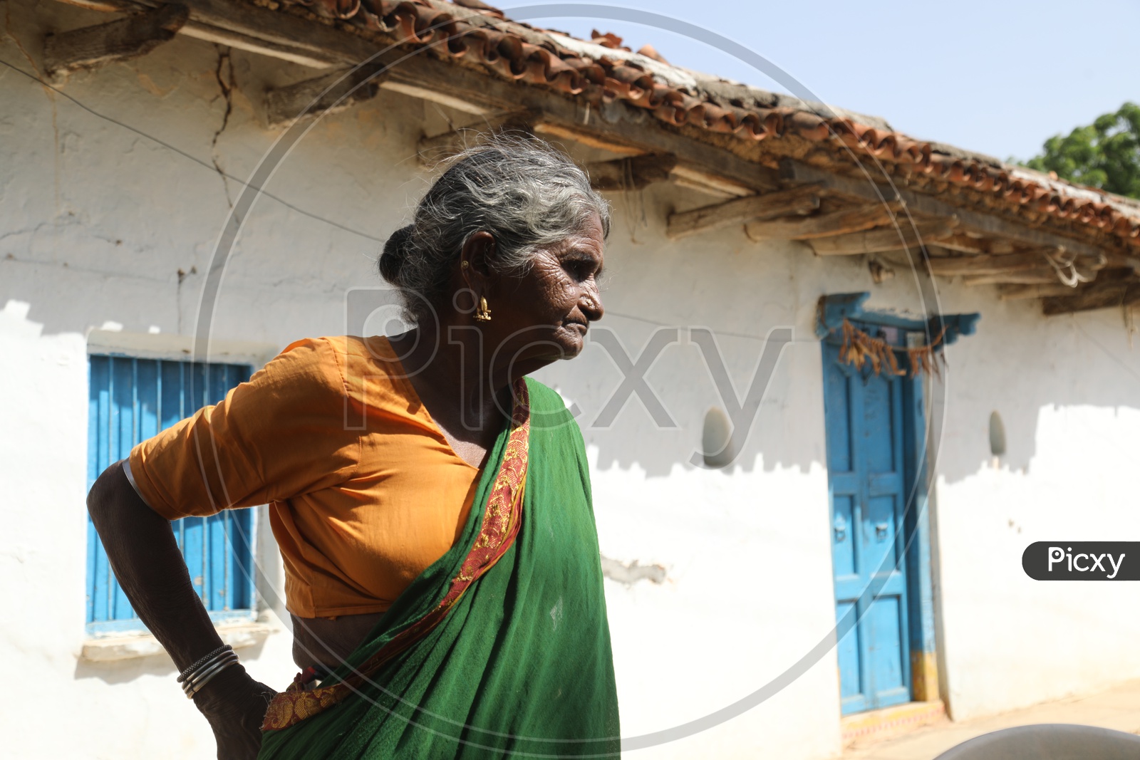 An Old Woman  of a Rural Village  at Her House Premise