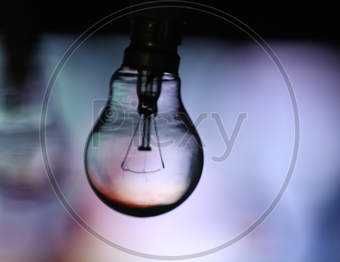 Electric Bulb Or tungsten Bulb Over a Bright led Light Bokeh Background