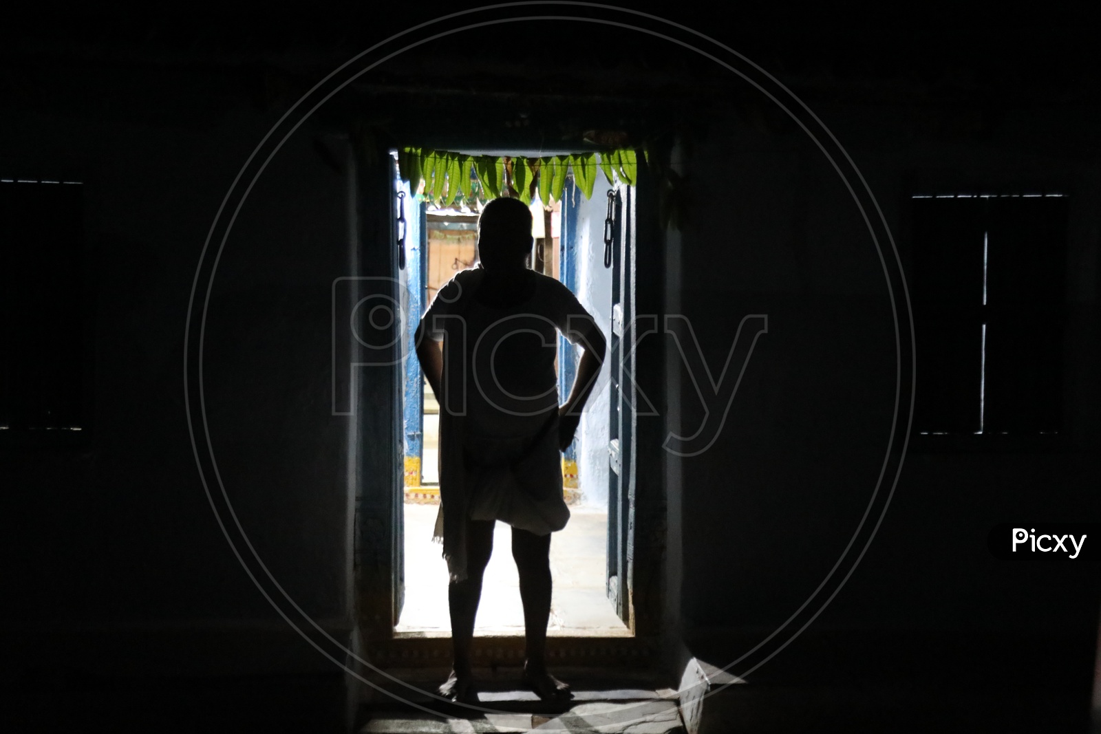 Silhouette Of an Indian Rural Village Man Standing at a House Door Step